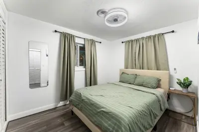 a bedroom with a bed with a green blanket at Sunrise Getaway in Sunrise