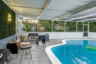 a patio with a swimming pool and a table and chairs at Sunrise Getaway in Sunrise
