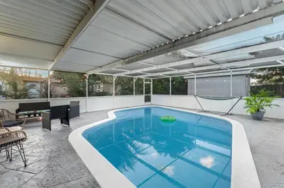 a swimming pool in a patio with a roof at Sunrise Getaway in Sunrise