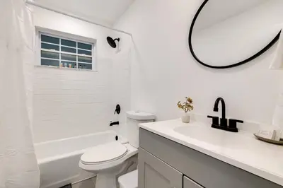 a white bathroom with a toilet and a sink and a mirror at Central 1b apt Next to Airport Virg 12 in Miami