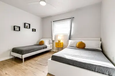 a white bedroom with a bed and a window at Spacious 2 BR near Miami Airport Virg 5 in Miami