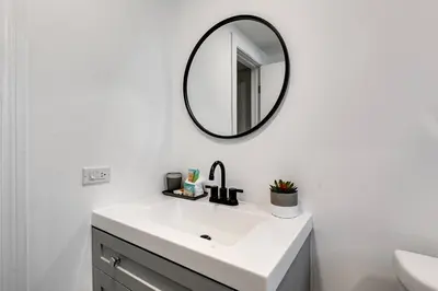 a bathroom with a white sink and a mirror at Roomy 2 BR near Miami Airport Virg 7 in Miami