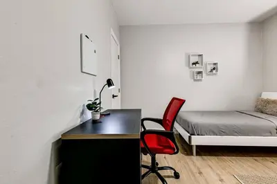 a bedroom with a desk and a bed and a chair at Roomy 2 BR near Miami Airport Virg 7 in Miami