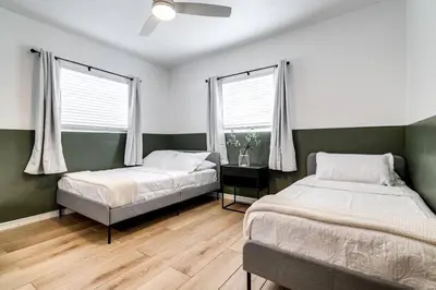 a bedroom with two beds and a ceiling fan at Miami Airport 2-bedroom unit with speedy Wi-Fi Virg8 in Miami