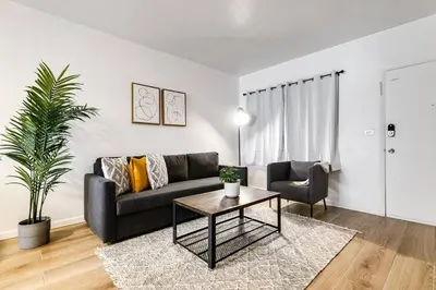 a living room with a black couch and a table at Miami Airport 2-bedroom unit with speedy Wi-Fi Virg8 in Miami