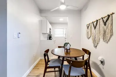 a dining room with a table and chairs at Stylish 2BR central Fast Wi fi virg2 in Miami