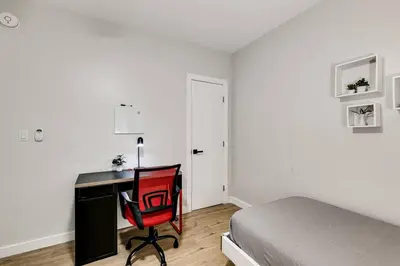 a bedroom with a desk and a bed and a red chair at Mia Springs 2BR wi-fi Virg 3 in Miami