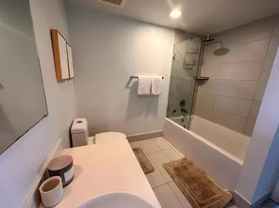 a white bathroom with a toilet and a shower at Exclusive Miami Beach Stay , Views & Modern Comfort -A in Hallandale Beach