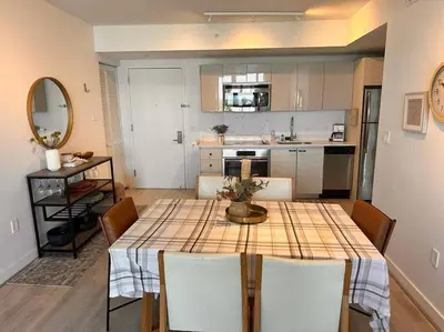 a kitchen and dining room with a table and chairs at Exclusive Miami Beach Stay , Views & Modern Comfort -A in Hallandale Beach