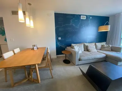 a living room with a table and a couch at Oceanfront Elegance, Full Kitchen & Miami Beach Charm -A in Hallandale Beach