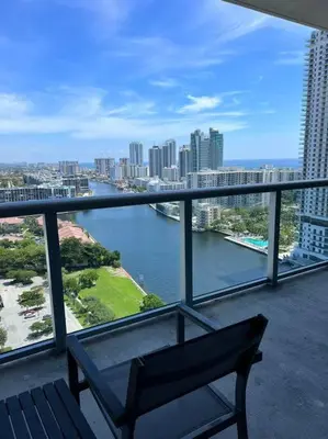 a bench on a balcony with a view of a river at Seaside Style in Miami, Modern Comfort & Full Kitchen -A in Hallandale Beach