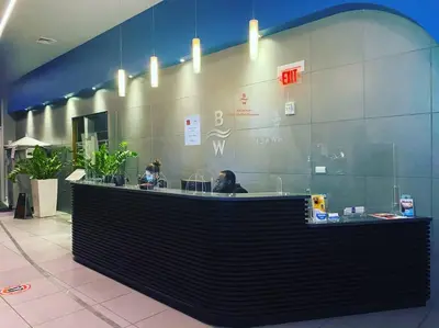 a lobby with a counter with people sitting at it at Feel the Miami Vibe , Cozy & Stylish Studio Stay in Hallandale Beach