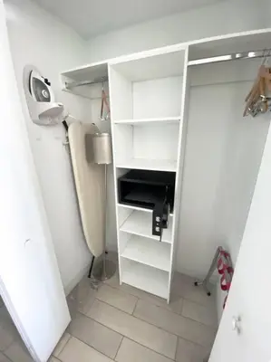 a bathroom with a closet with white shelves and a sink at elax & Recharge in This Incredible Miami Studio in Hallandale Beach