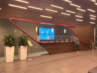 a woman standing at a counter in an airport at Make Yourself at Home , Inviting Studio in Miami in Hallandale Beach