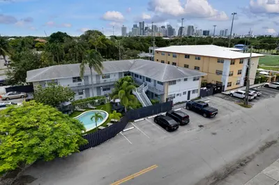 an aerial view of a building with cars parked in a parking lot at Holiday Park Apartments by Lowkl in Fort Lauderdale