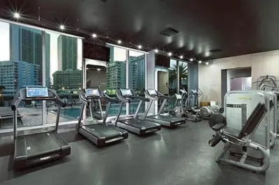 a gym with treadmills and elliptical machines in a building at Cozy Miami Studio Perfect for Vacation or Work! in Hallandale Beach