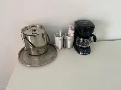 a coffee maker and coffee cups on a counter at Modern Miami Studio with 2 full beds, Cozy & Convenient in Hallandale Beach
