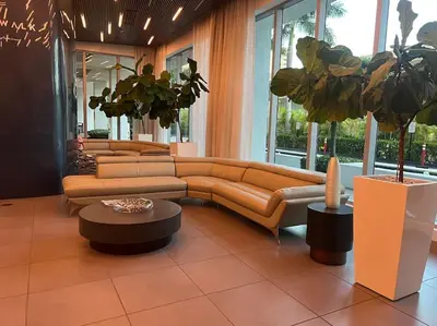 a living room with a couch and a table at Oceanfront Studio with Beach, Pool & Restaurants in Hallandale Beach