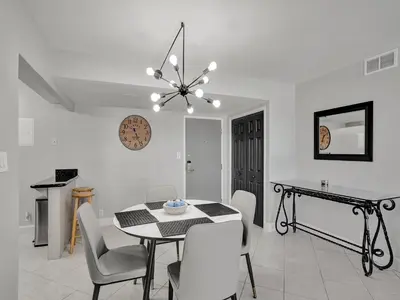 a kitchen and dining room with a table and chairs at Cozy Beachfront 2 BDR Miami Beach Condo 406 in Miami Beach