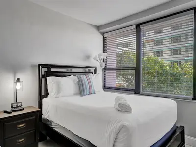 a bedroom with a large white bed and a window at Cozy Beachfront 2 BDR Miami Beach Condo 406 in Miami Beach