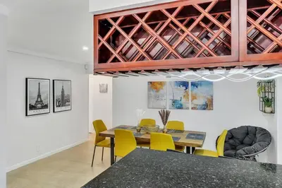 a dining room with a table and yellow chairs at Vacation Villa W Heated Pool Beach & Casino in Hollywood