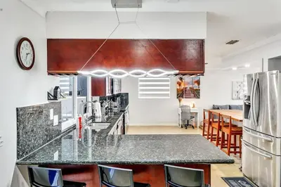 a kitchen with a counter top and a refrigerator at Vacation Villa W Heated Pool Beach & Casino in Hollywood