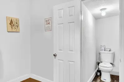 a bathroom with a toilet and a white door at Hallandale Mins From Beach & Aventura Mall Hn01 in Hallandale Beach