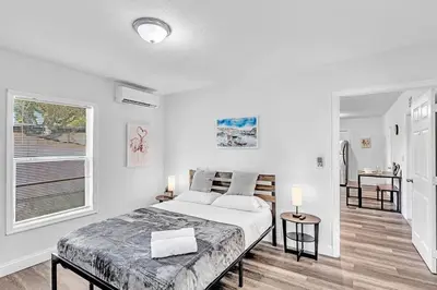a white bedroom with a bed and a window at Hallandale Mins From Beach & Aventura Mall Hn01 in Hallandale Beach