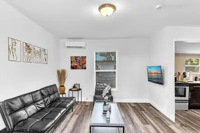 a living room with a leather couch and a table at Hallandale Mins From Beach & Aventura Mall Hn01 in Hallandale Beach