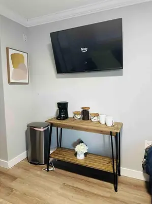a small table with a television on a wall at Coral Gables Miami Studio near Airport and Beaches in Miami