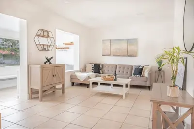 a living room with a couch and a table at Coral Gables Home with POOL Near Airport. King beds in Miami