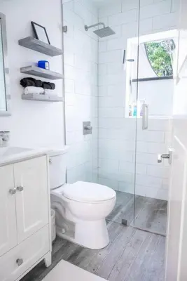 a white bathroom with a toilet and a glass shower at Coral Gables Home with POOL Near Airport. King beds in Miami