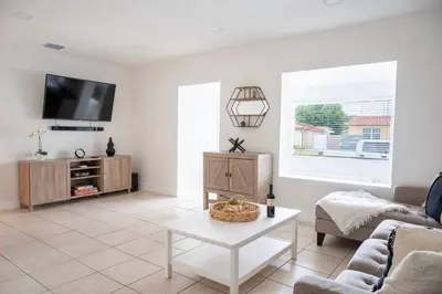 a living room with a couch and a table at Coral Gables Home with POOL Near Airport. King beds in Miami