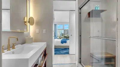 a white bathroom with a sink and a shower at Your Private Oceanfront Sanctuary 2BR 2BA in Fort Lauderdale
