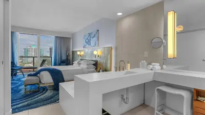 a hotel room with a bed and a sink at Your Private Oceanfront Sanctuary 2BR 2BA in Fort Lauderdale