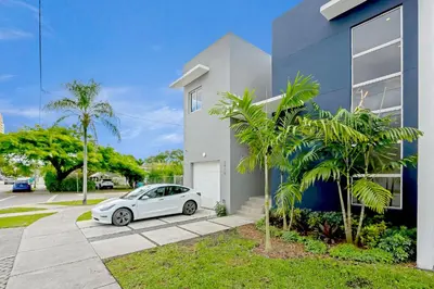 a white car parked in front of a house at Deco Delight - Central Hub in Miami
