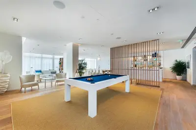 a living room with a pool table in it at Tiffany Hazel - Rooftop Pool, Gym, & Walk to Beach in Fort Lauderdale