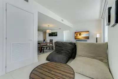 a living room with a couch and a table at Tiffany Blanca - Rooftop Pool, Gym, & Walk to Beach in Fort Lauderdale