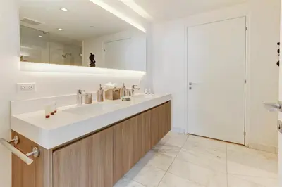 a bathroom with a sink and a mirror at Tiffany Blanca - Rooftop Pool, Gym, & Walk to Beach in Fort Lauderdale