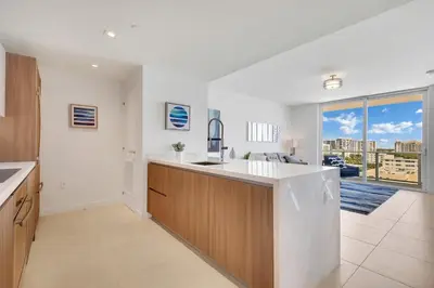 a kitchen with a sink and a large window at Tiffany Indigo - Rooftop Pool, Gym, Walk to Beach in Fort Lauderdale