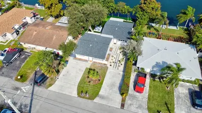 an overhead view of a street with houses and cars at Renovated professional design, grill lake view! in Hallandale Beach
