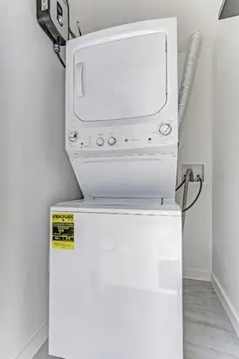 a microwave oven sitting on top of a refrigerator at Renovated professional design, grill lake view! 1 in Hallandale Beach