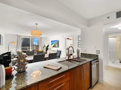 a kitchen with a counter top and a living room at Luxury Brickell Waterfront View - Amazing Furnished Balcony - Walk-Water-WiFi in Miami