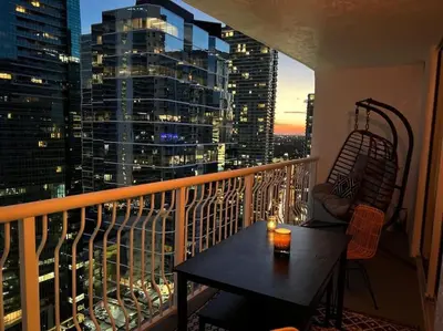 a balcony with a table and a view of a city at Luxury Brickell Waterfront View - Amazing Furnished Balcony - Walk-Water-WiFi in Miami