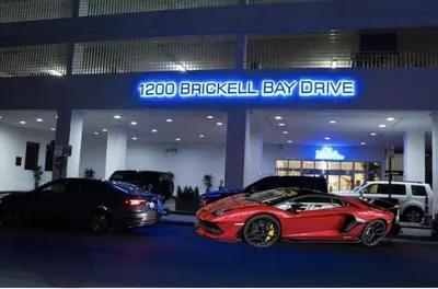 a red car parked in front of a car dealership at Luxury Brickell Waterfront View - Amazing Furnished Balcony - Walk-Water-WiFi in Miami