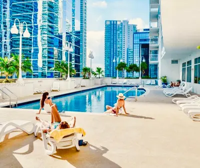 a group of people playing in the pool at a resort at Luxury Brickell Waterfront View - Amazing Furnished Balcony - Walk-Water-WiFi in Miami