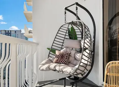 a hanging chair with pillows on a balcony at Luxury Brickell Waterfront View - Amazing Furnished Balcony - Walk-Water-WiFi in Miami