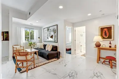 a living room with a couch and a table at Artease 2 -Largest, stylish, Peloton bike, near Wynwood Walls & restaurants in Miami