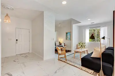 a living room with a couch and a table at Artease 2 -Largest, stylish, Peloton bike, near Wynwood Walls & restaurants in Miami
