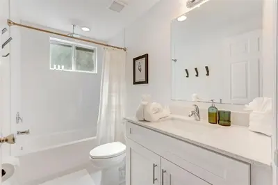 a white bathroom with a toilet and a sink at Artease 2 -Largest, stylish, Peloton bike, near Wynwood Walls & restaurants in Miami